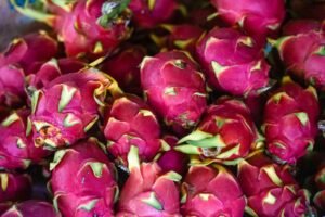 green and pink tropical fruits